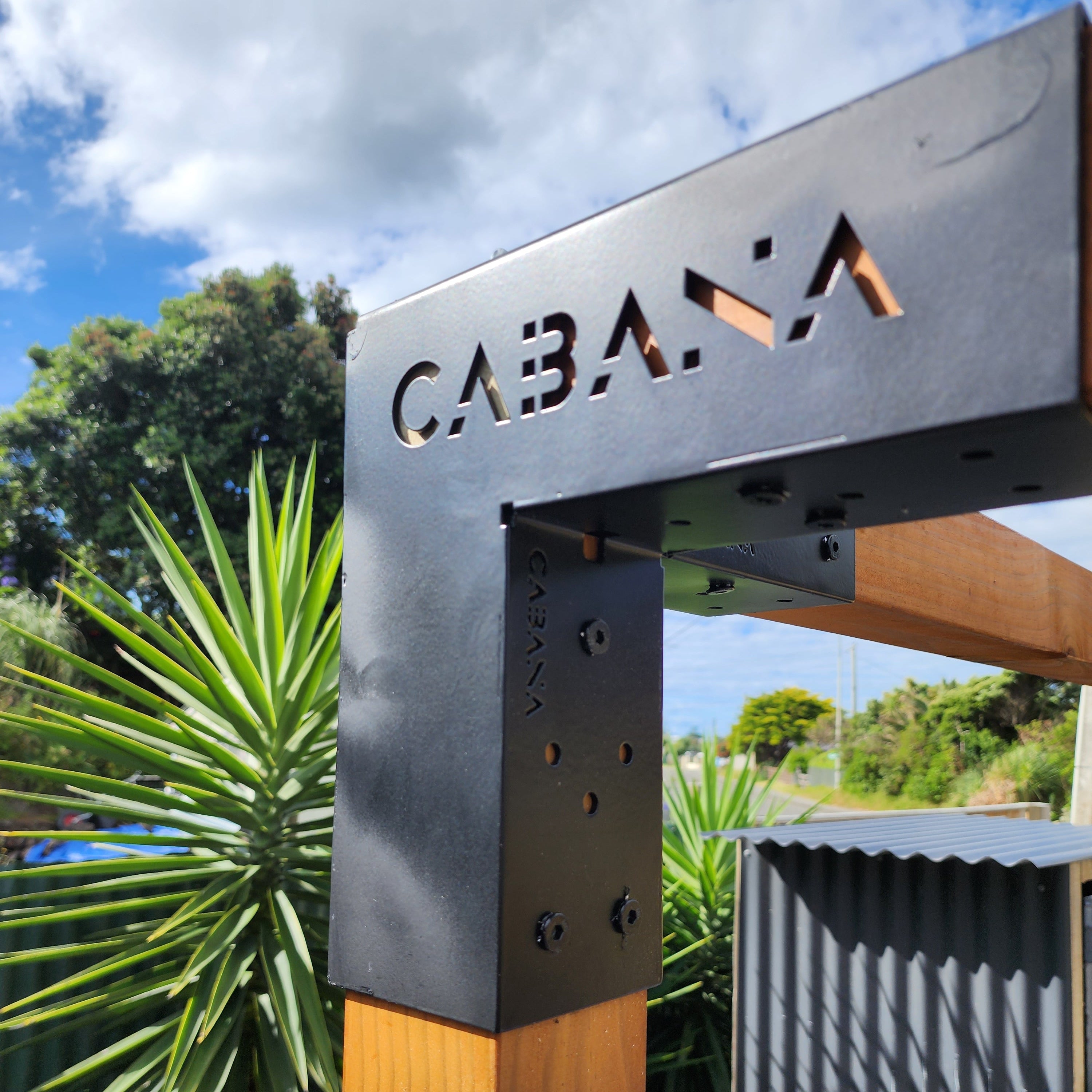 Metal bracket with 'Cabana' branding against a natural background